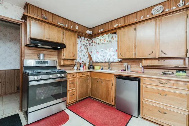 a kitchen with stainless steel appliances granite countertop a stove and a sink