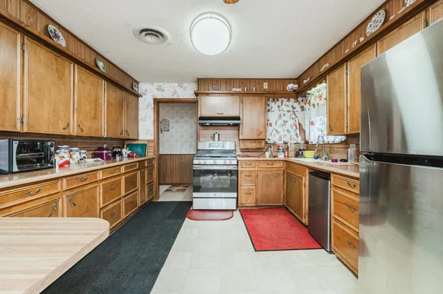 a kitchen with sink cabinets and stainless steel appliances