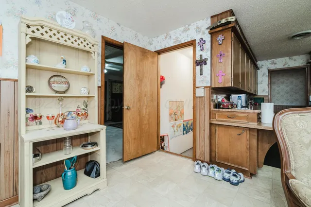 a kitchen with refrigerator and cabinets