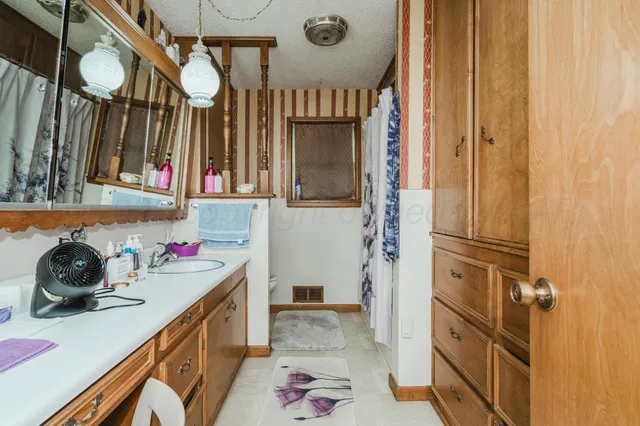 a bathroom with a sink a vanity and a mirror