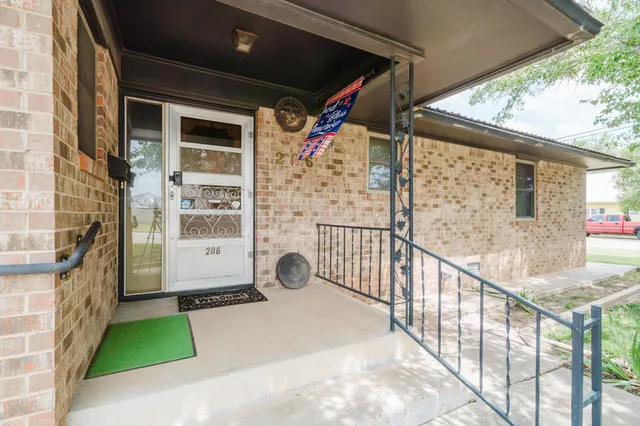 a view of a porch with wooden floor and iron stairs