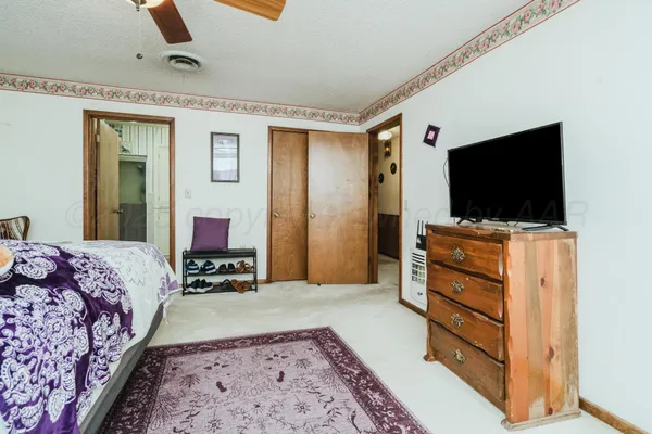 a bedroom with a bed and flat screen tv