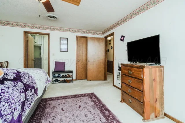 a bedroom with a bed and flat screen tv