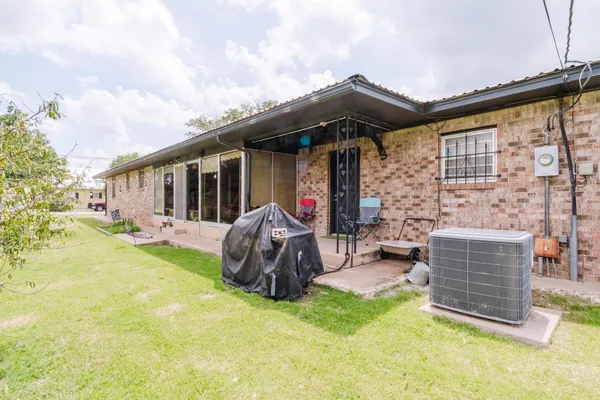 a backyard of a house with yard and outdoor seating