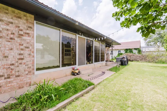 a swimming pool with outdoor seating and yard