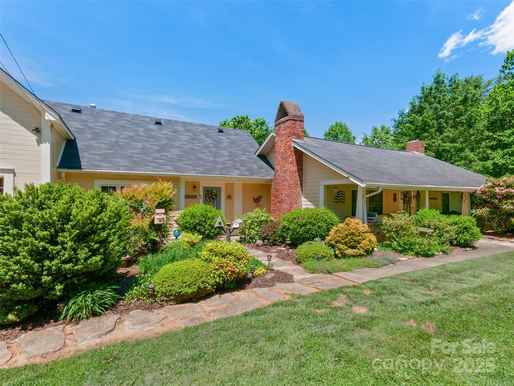 229 Crabtree Mountain Road Canton, NC 28716 - Photo 2 of 42 a front view of a house with a yard