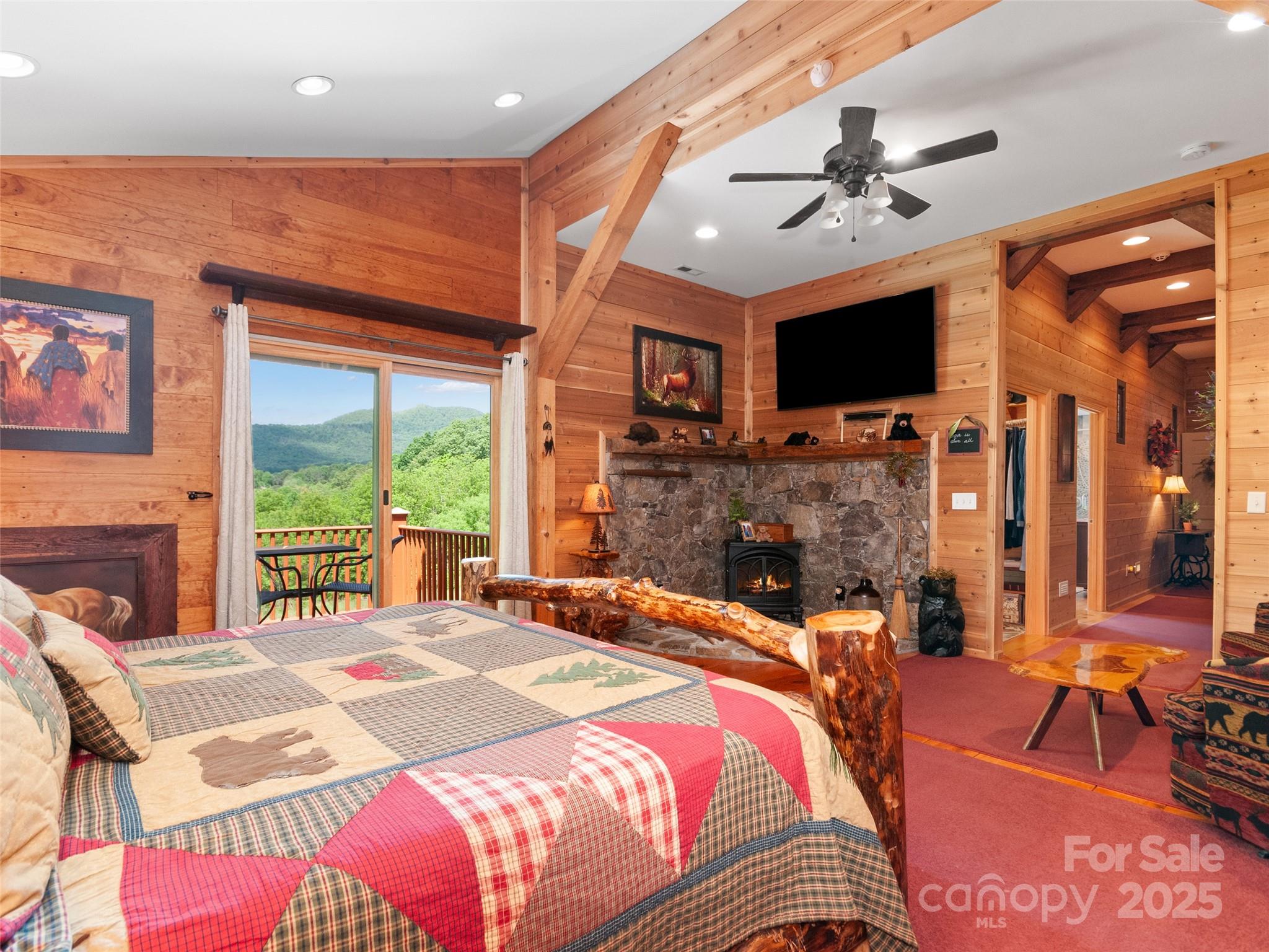 229 Crabtree Mountain Road Canton, NC 28716 - Photo 26 of 42 a bedroom with a bed and a flat screen tv