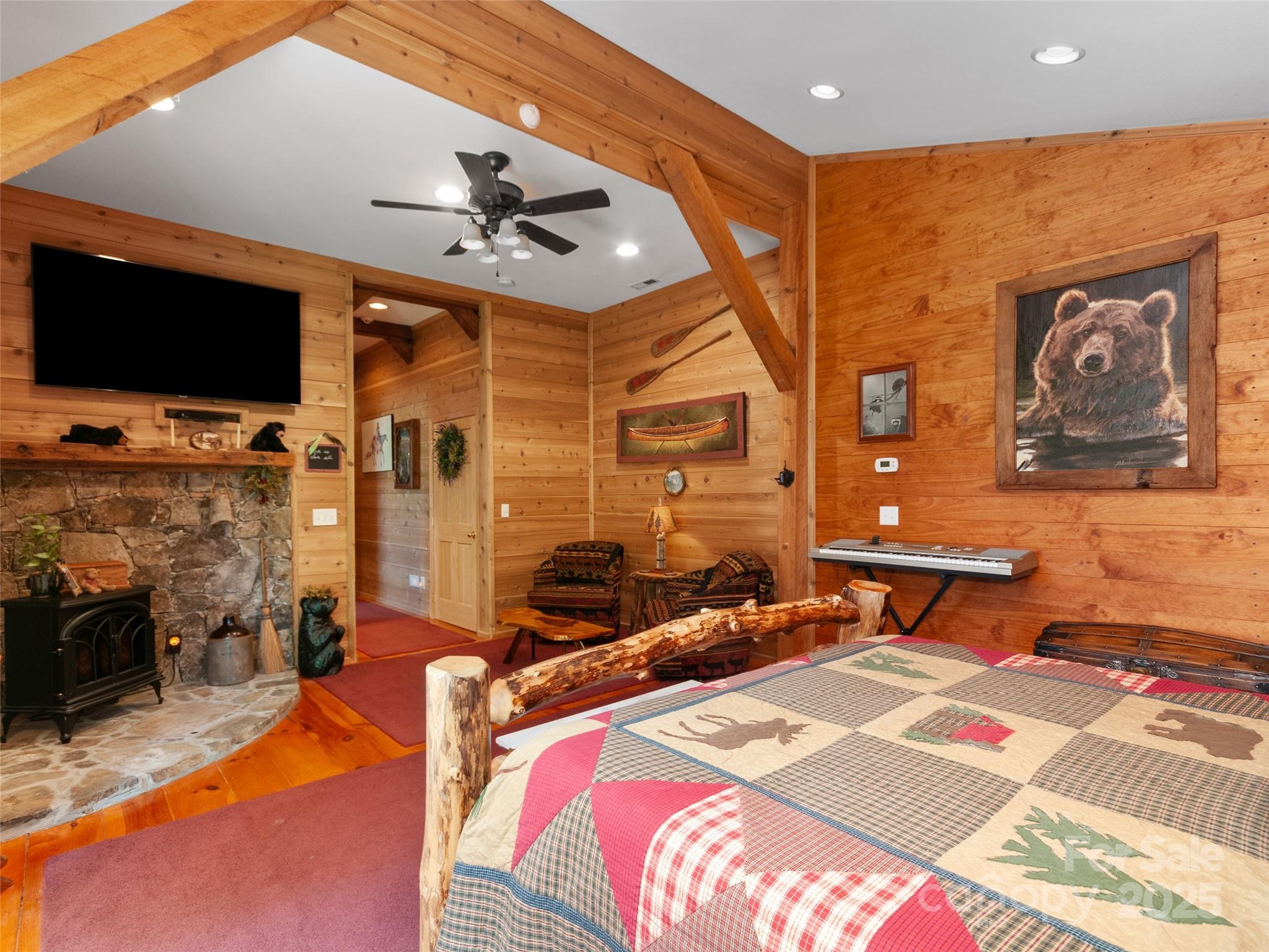 229 Crabtree Mountain Road Canton, NC 28716 - Photo 30 of 42 a bedroom with a bed and flat screen tv