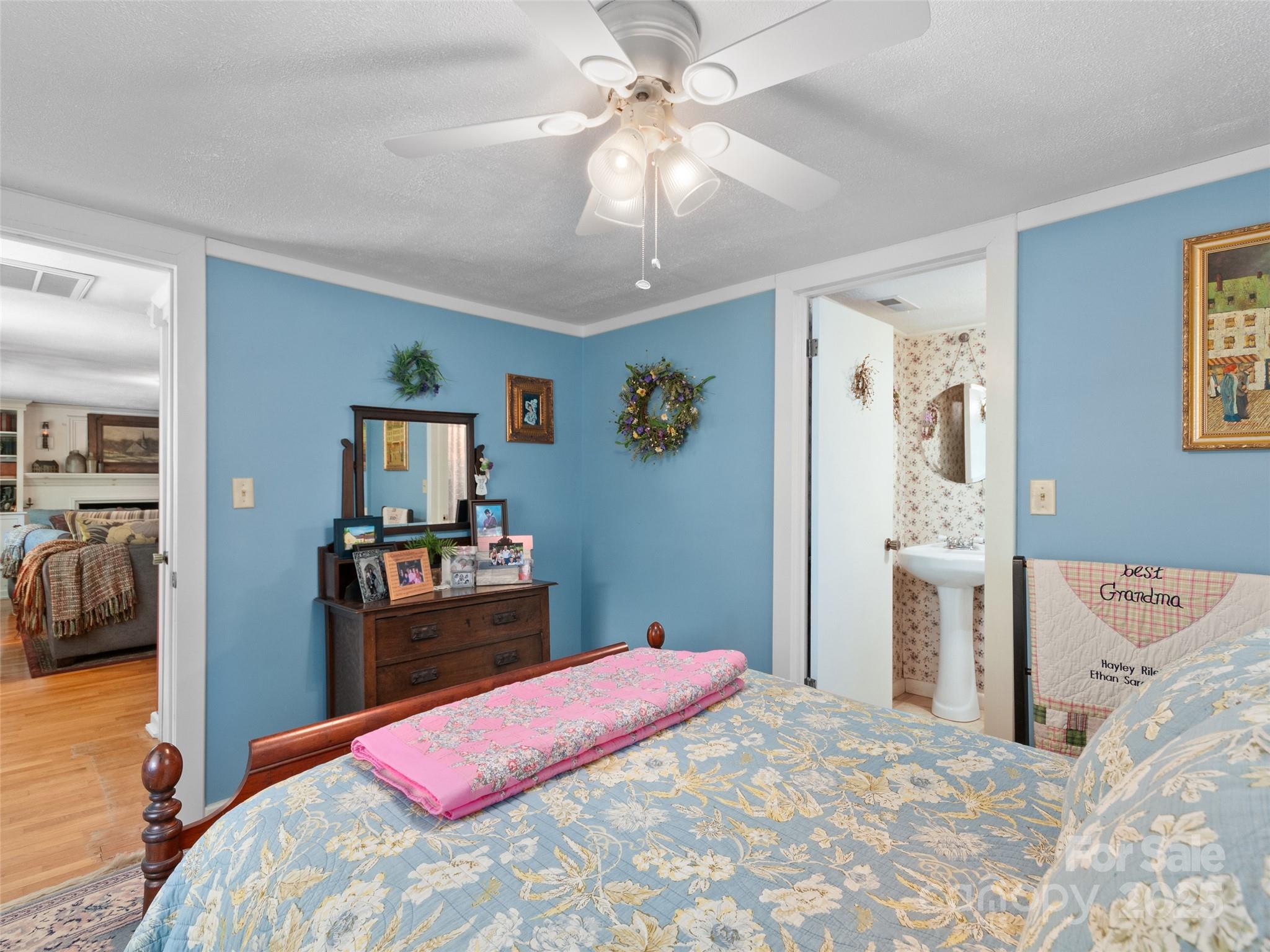 229 Crabtree Mountain Road Canton, NC 28716 - Photo 8 of 42 a bedroom with a bed and a chandelier