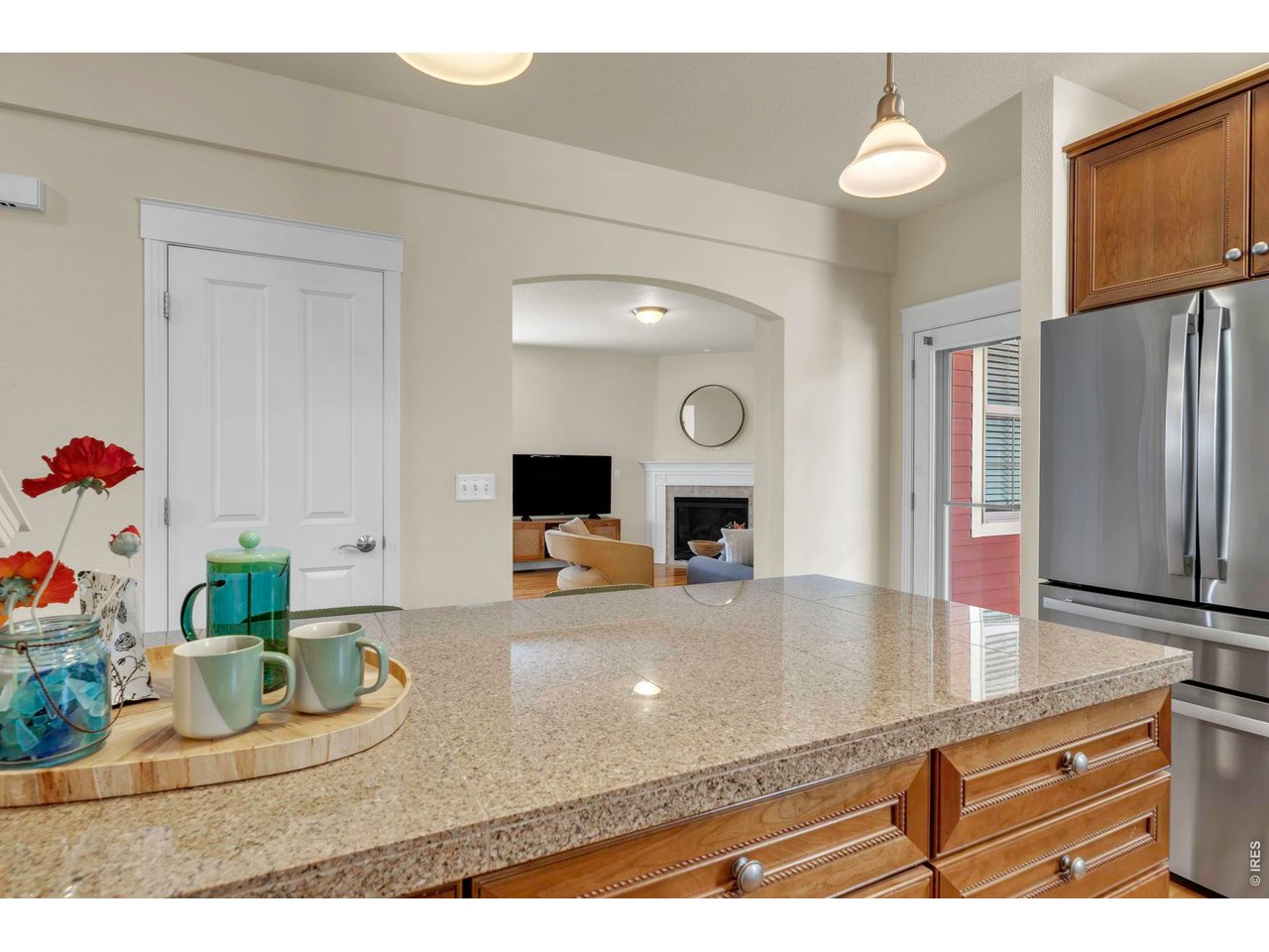 696 Homestead Street Lafayette, CO 80026 - Photo 18 of 49 a kitchen with kitchen island a sink appliances and cabinets