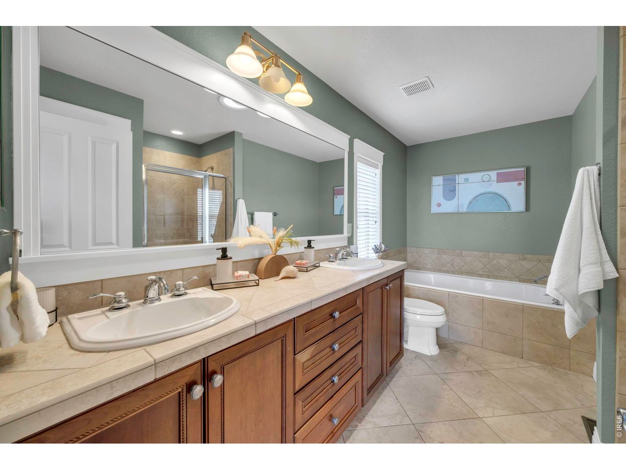 696 Homestead Street Lafayette, CO 80026 - Photo 28 of 49 a bathroom with a granite countertop sink mirror vanity and a