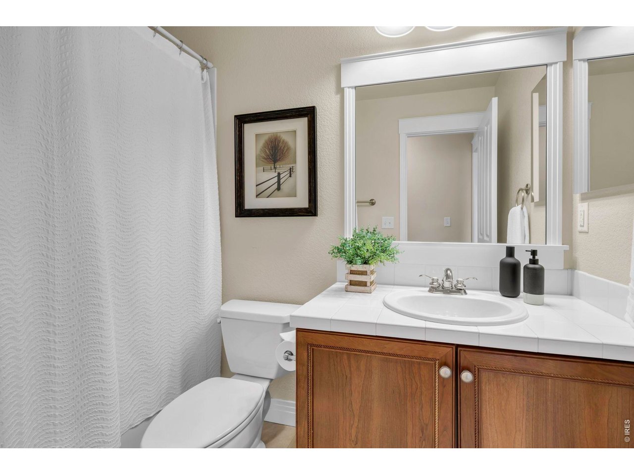 696 Homestead Street Lafayette, CO 80026 - Photo 33 of 49 a bathroom with a granite countertop sink mirror vanity and toilet
