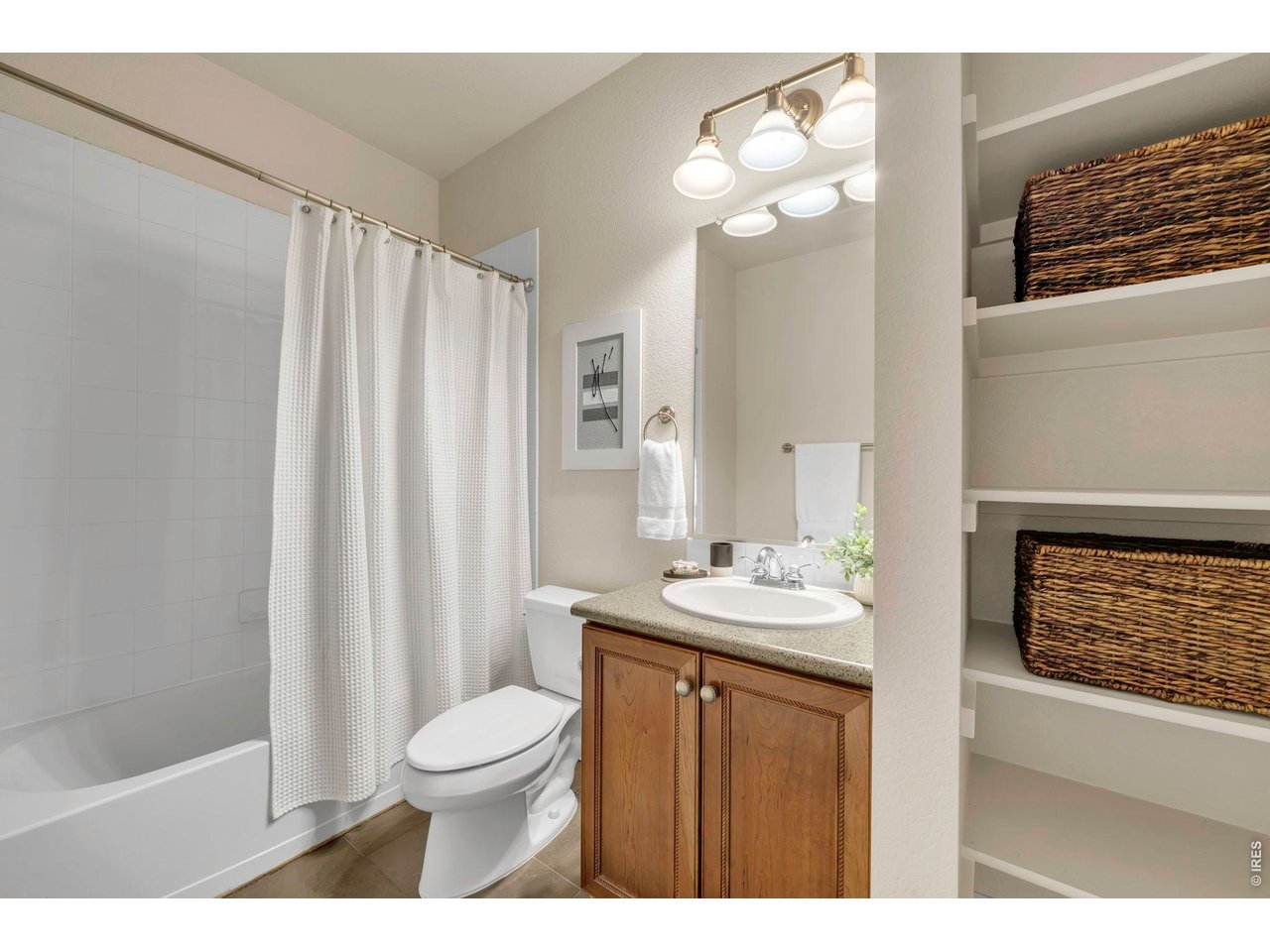 696 Homestead Street Lafayette, CO 80026 - Photo 39 of 49 a bathroom with a granite countertop sink toilet a mirror a vanity and shower