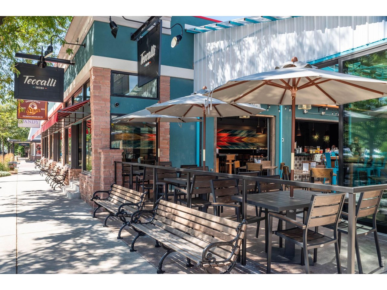 696 Homestead Street Lafayette, CO 80026 - Photo 46 of 49 a view of a cafe with a table and chairs under an umbrella