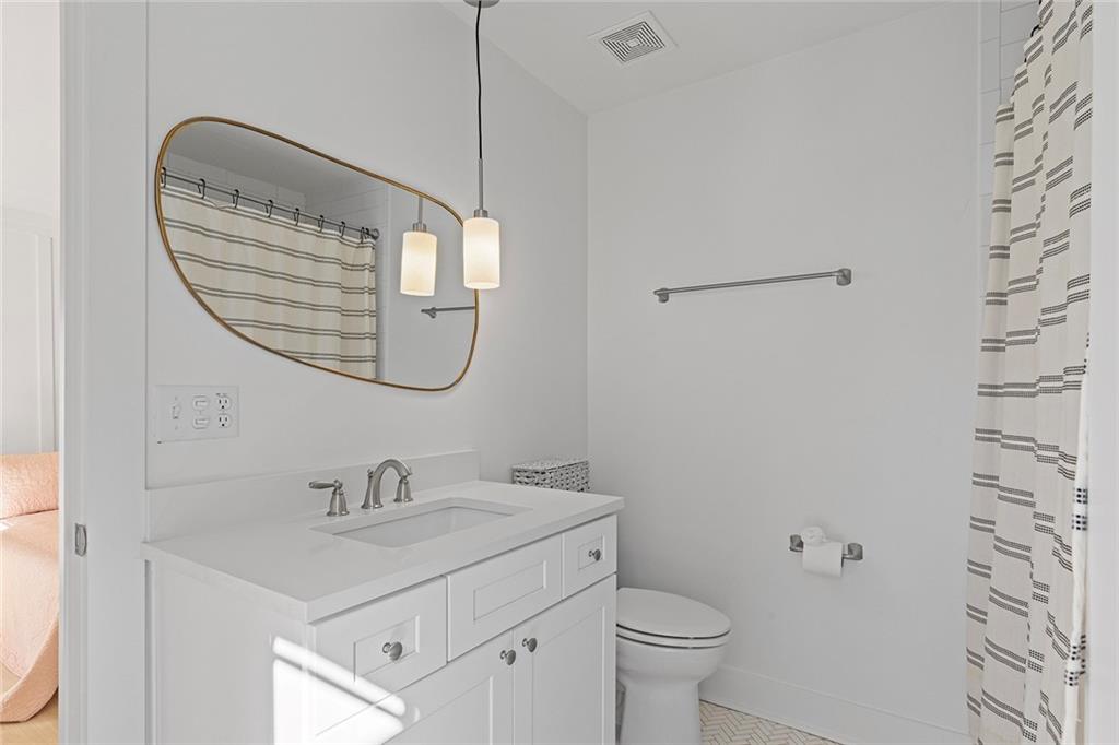 12005 Hamilton Road Chattahoochee Hills, GA 30268 - Photo 26 of 51 a bathroom with a sink a toilet and a mirror
