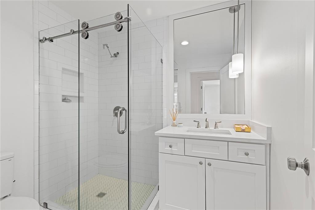 12005 Hamilton Road Chattahoochee Hills, GA 30268 - Photo 29 of 51 a bathroom with a shower sink vanity and mirror