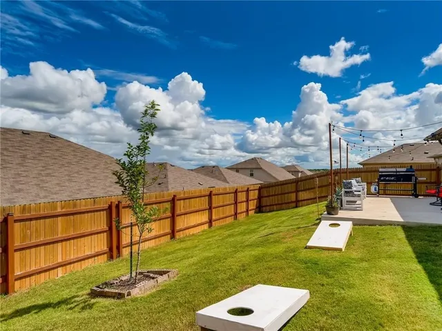 a swimming pool view with a seating space