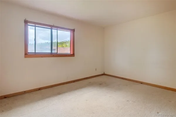a bedroom with furniture and a flat screen tv