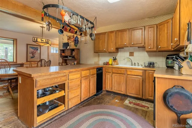 a kitchen with stainless steel appliances granite countertop a refrigerator microwave and sink