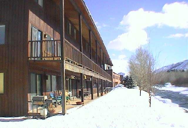 a view of a building with snow on the road