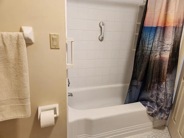 a bathroom with a bathtub and shower