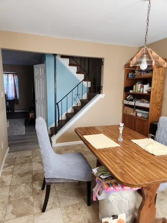 a dining room with furniture and window