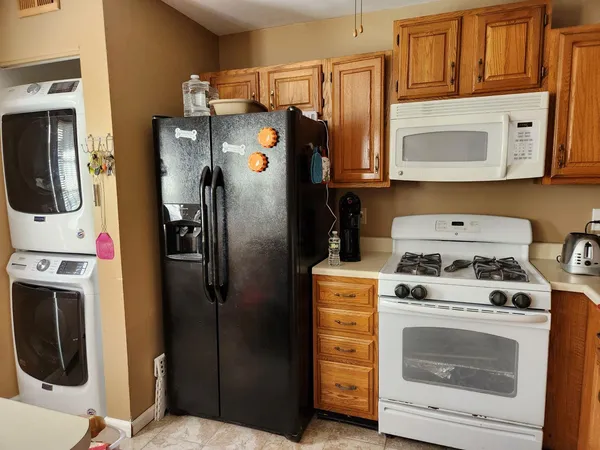 a kitchen with stainless steel appliances a stove a refrigerator and cabinets