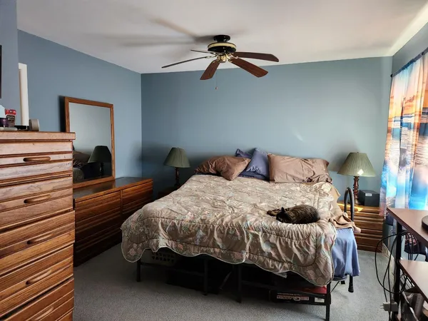a bedroom with a bed and window