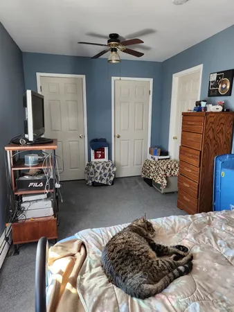 a bedroom with bed and a window