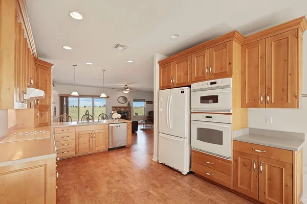 a kitchen with cabinets and a refrigerator