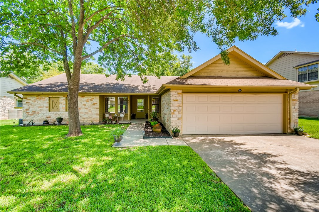 523 Pigeon Forge Road Pflugerville, TX 78660 - Photo 1 of 1 a front view of a house with yard and green space