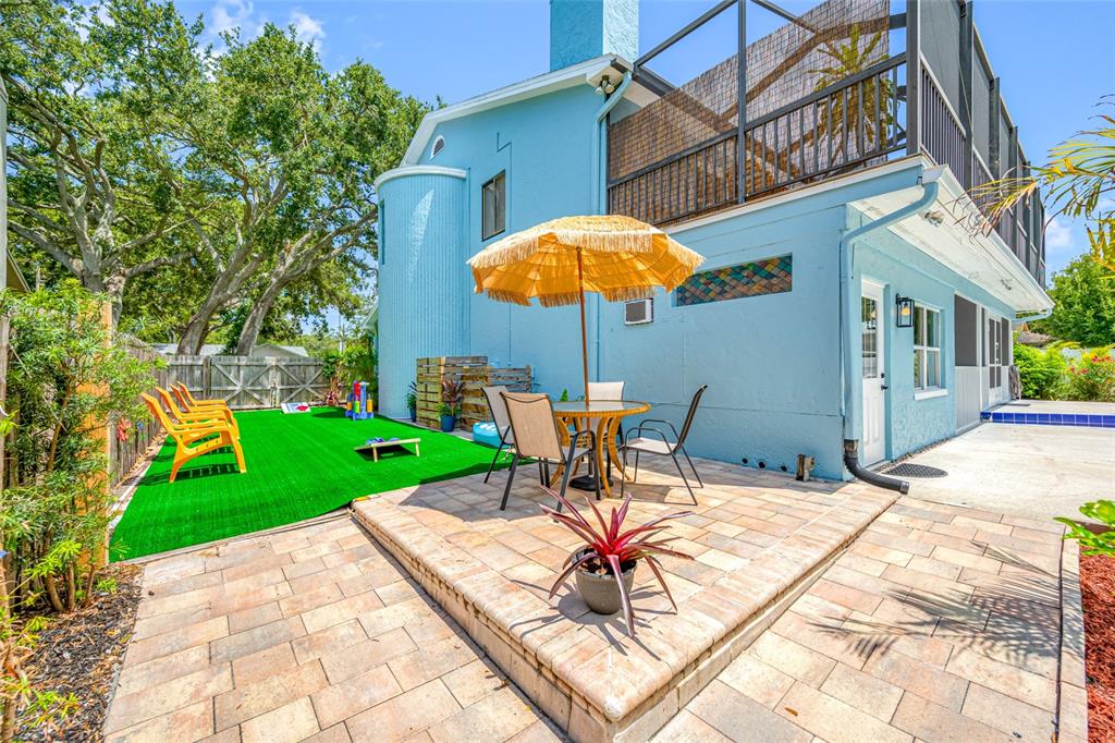 2153 Karan Way Clearwater, FL 33763 - Photo 62 of 65 a view of a backyard with a table and chairs under an umbrella