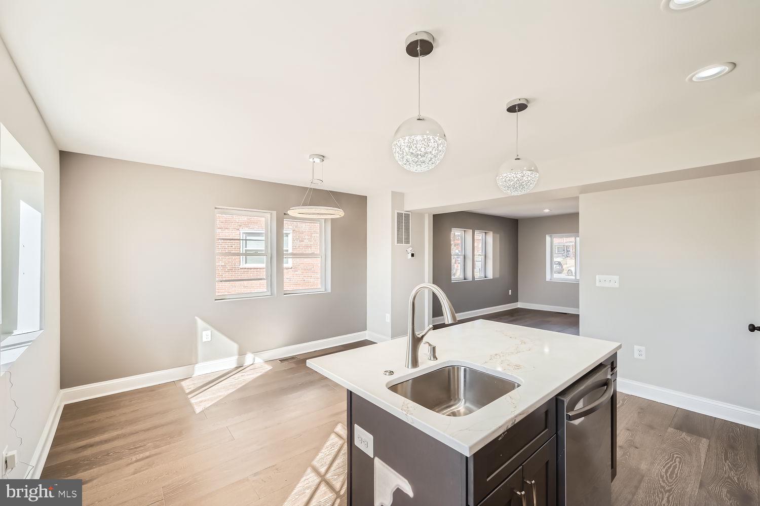 801 Bradhurst Road Baltimore, MD 21212 - Photo 11 of 26 a kitchen with a sink cabinets and window
