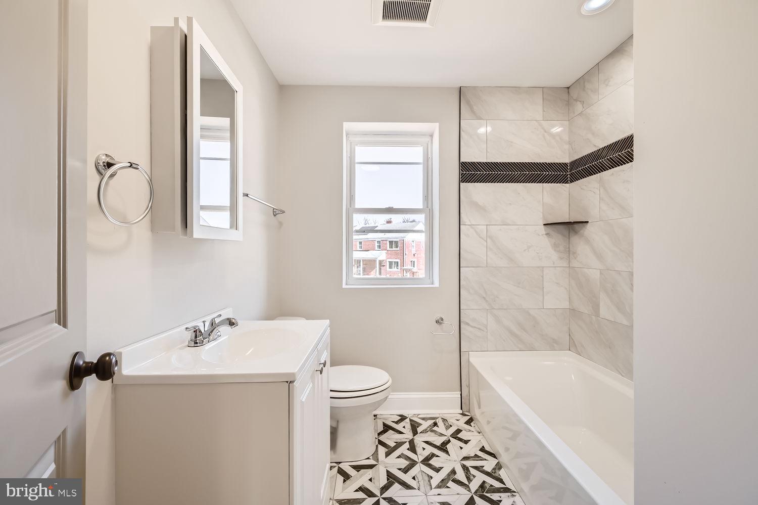 801 Bradhurst Road Baltimore, MD 21212 - Photo 15 of 26 a bathroom with a sink a toilet and shower