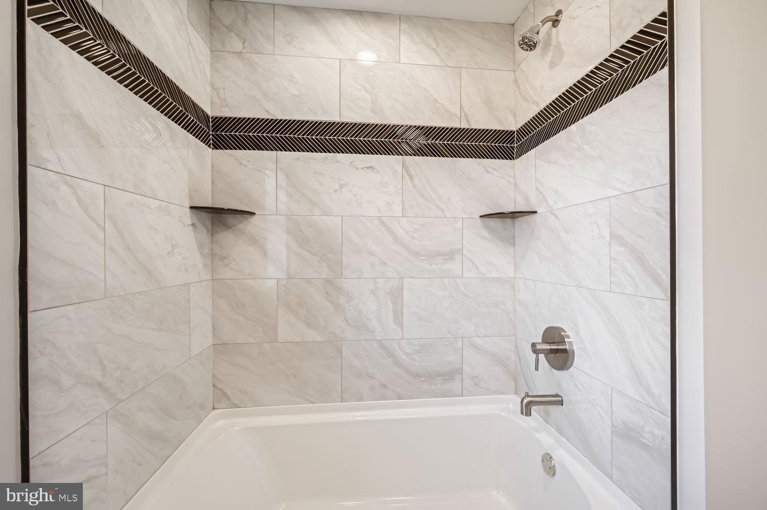 801 Bradhurst Road Baltimore, MD 21212 - Photo 17 of 26 a bathroom with a shower and a bathtub