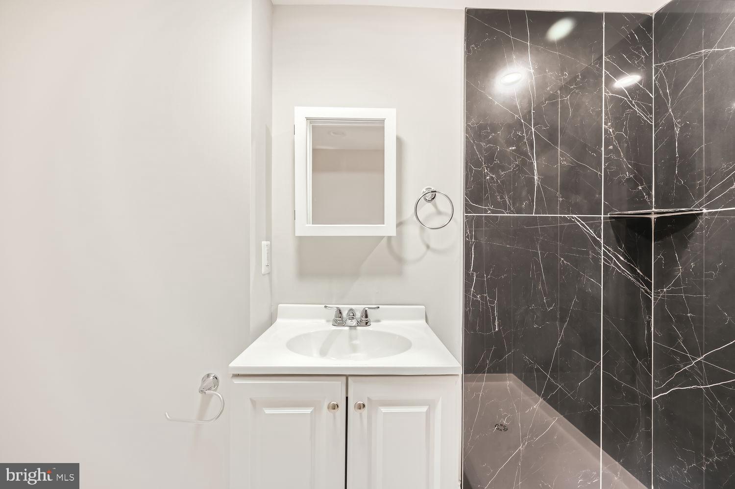 801 Bradhurst Road Baltimore, MD 21212 - Photo 20 of 26 a bathroom with a sink and a mirror