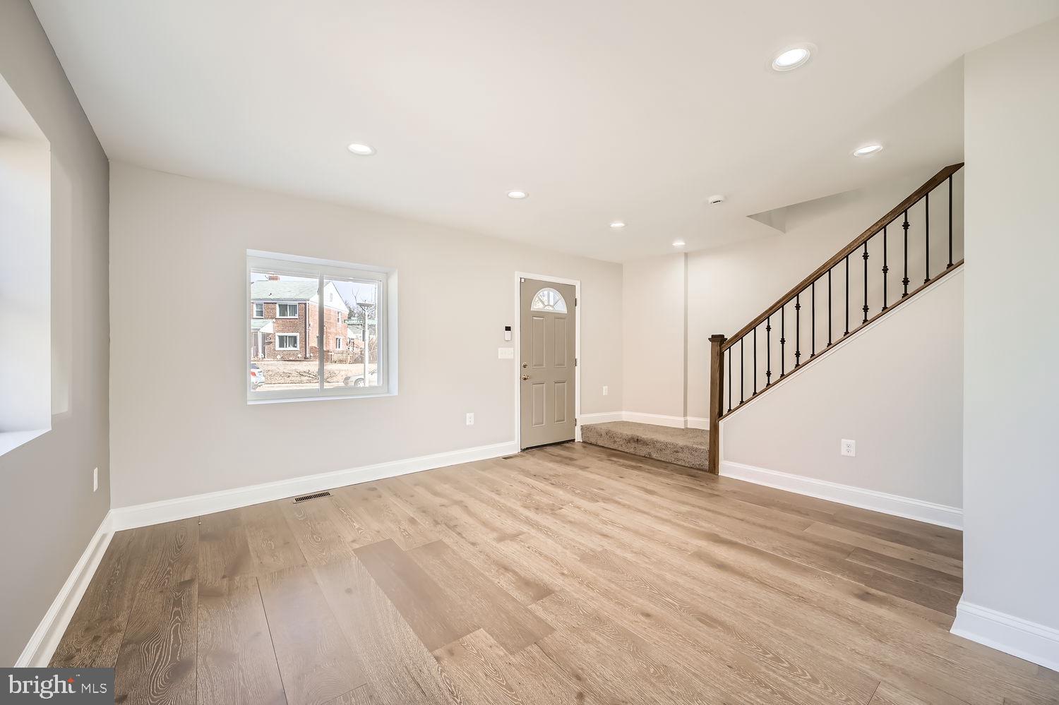 801 Bradhurst Road Baltimore, MD 21212 - Photo 5 of 26 a view of an empty room with wooden floor and a window