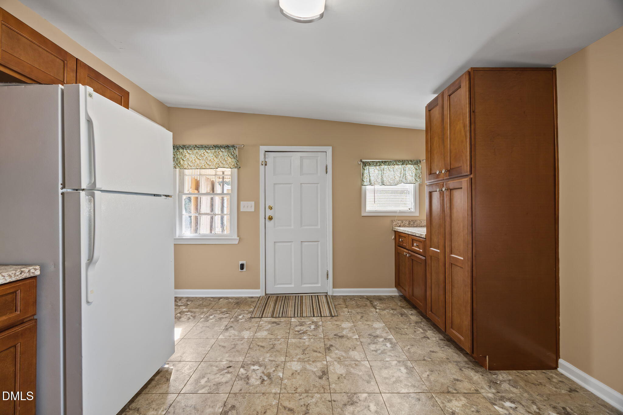 209 Weston Road Garner, NC 27529 - Photo 8 of 37 a view of an empty room with window and cabinet