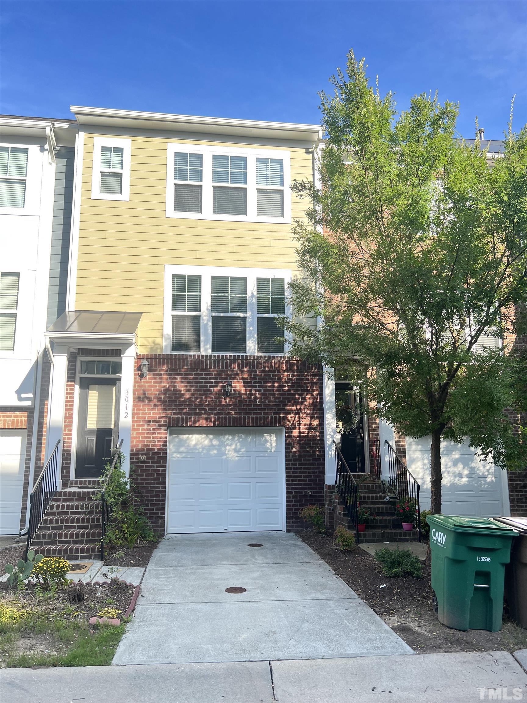 3012 Summerhouse Road Cary, NC 27519 - Photo 1 of 26 a front view of a house with a garden