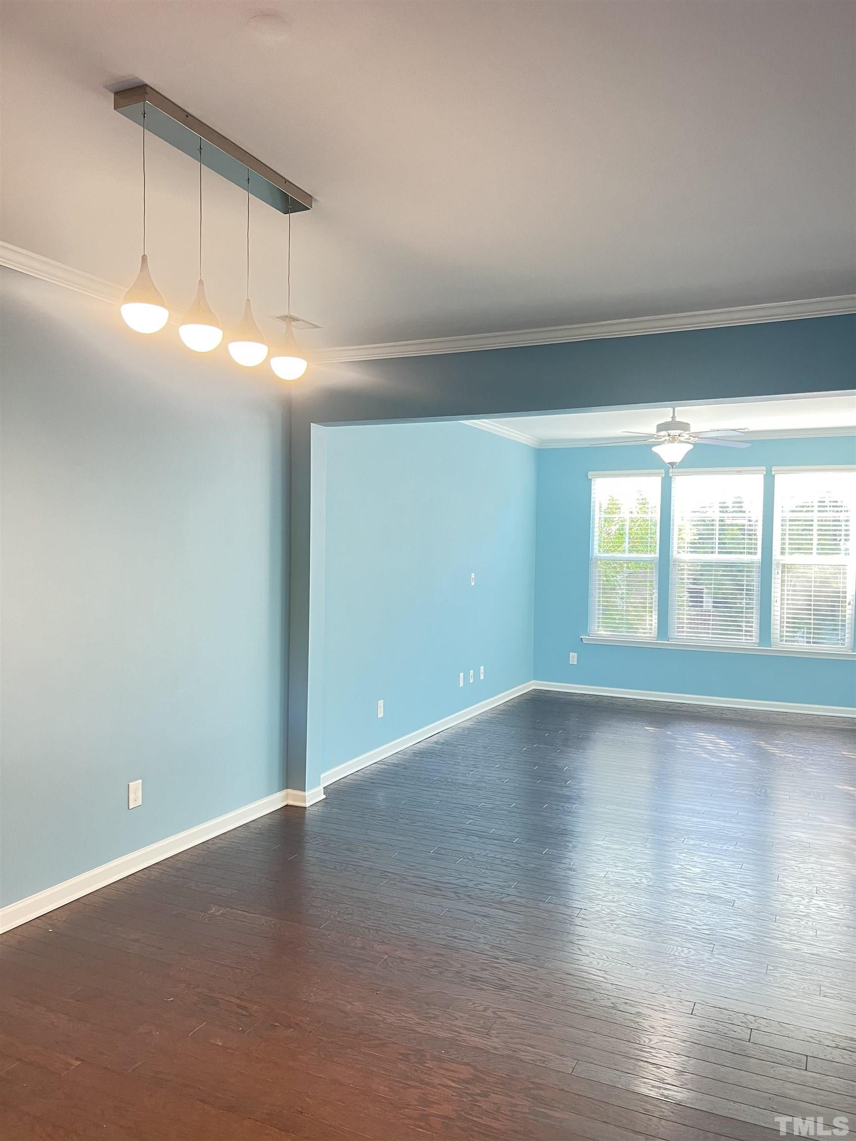 3012 Summerhouse Road Cary, NC 27519 - Photo 12 of 26 a view of an empty room with wooden floor and a window