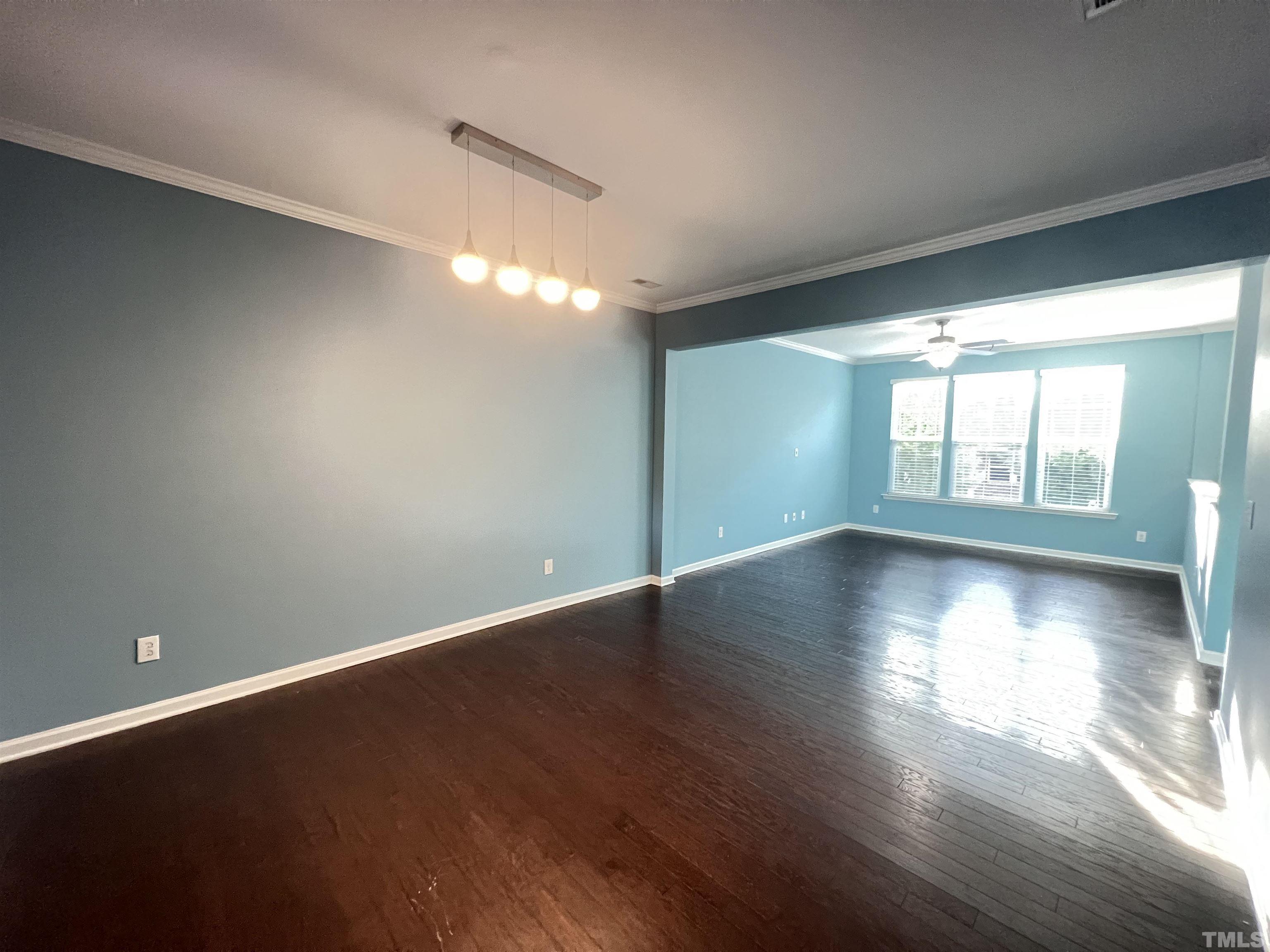 3012 Summerhouse Road Cary, NC 27519 - Photo 13 of 26 an empty room with wooden floor and windows