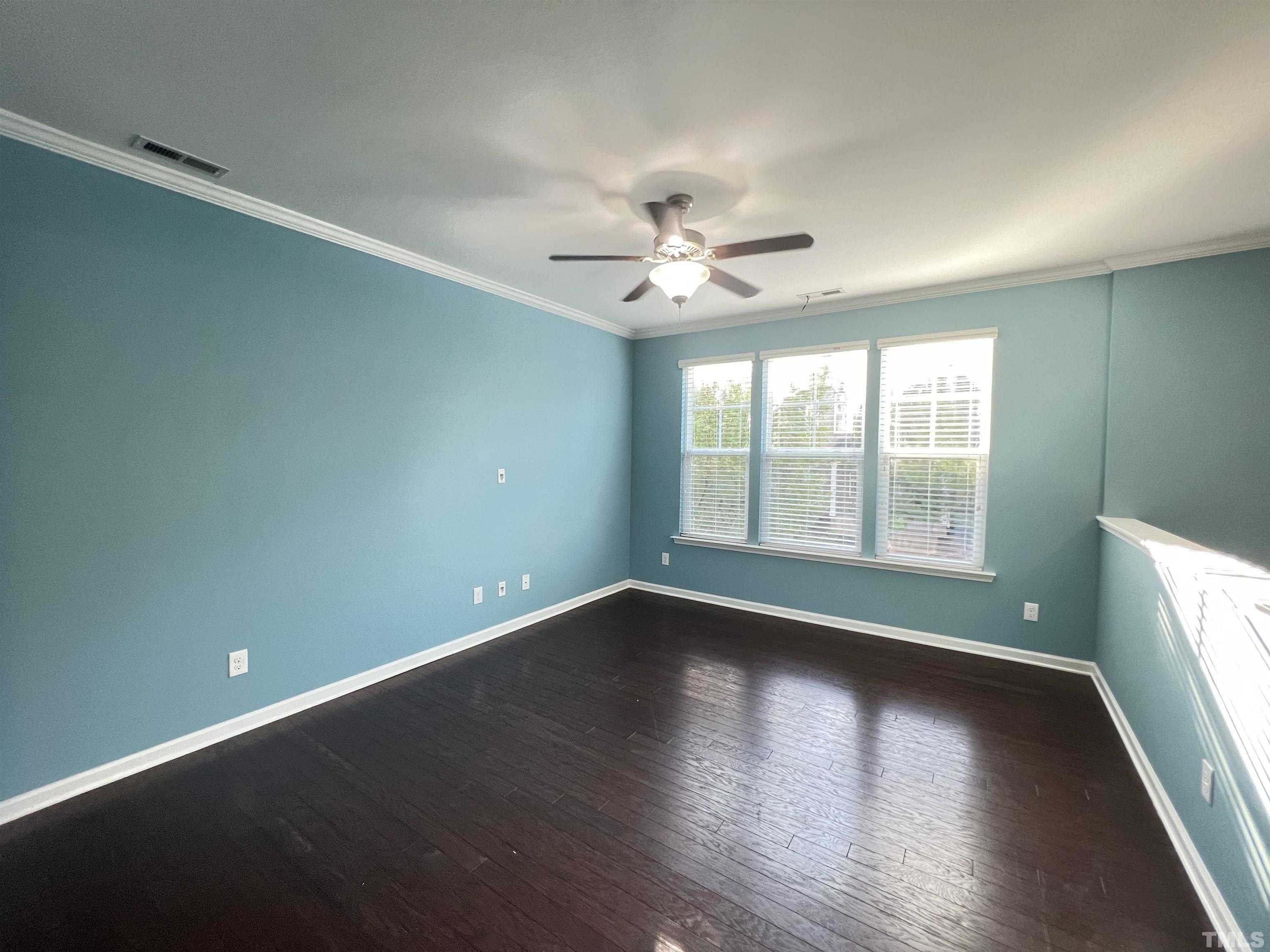 3012 Summerhouse Road Cary, NC 27519 - Photo 14 of 26 an empty room with wooden floor and windows