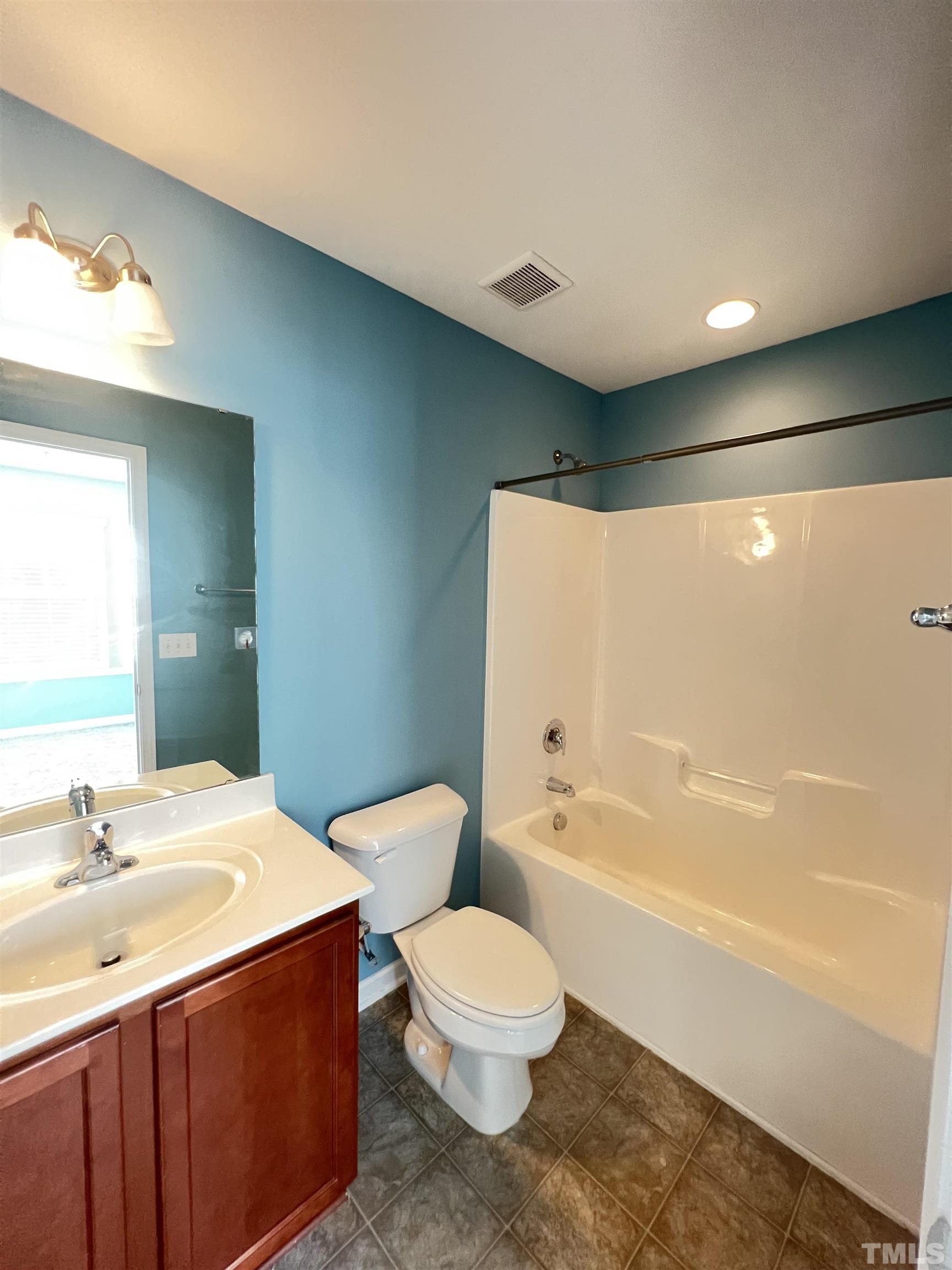3012 Summerhouse Road Cary, NC 27519 - Photo 17 of 26 a bathroom with a toilet a sink and bathtub