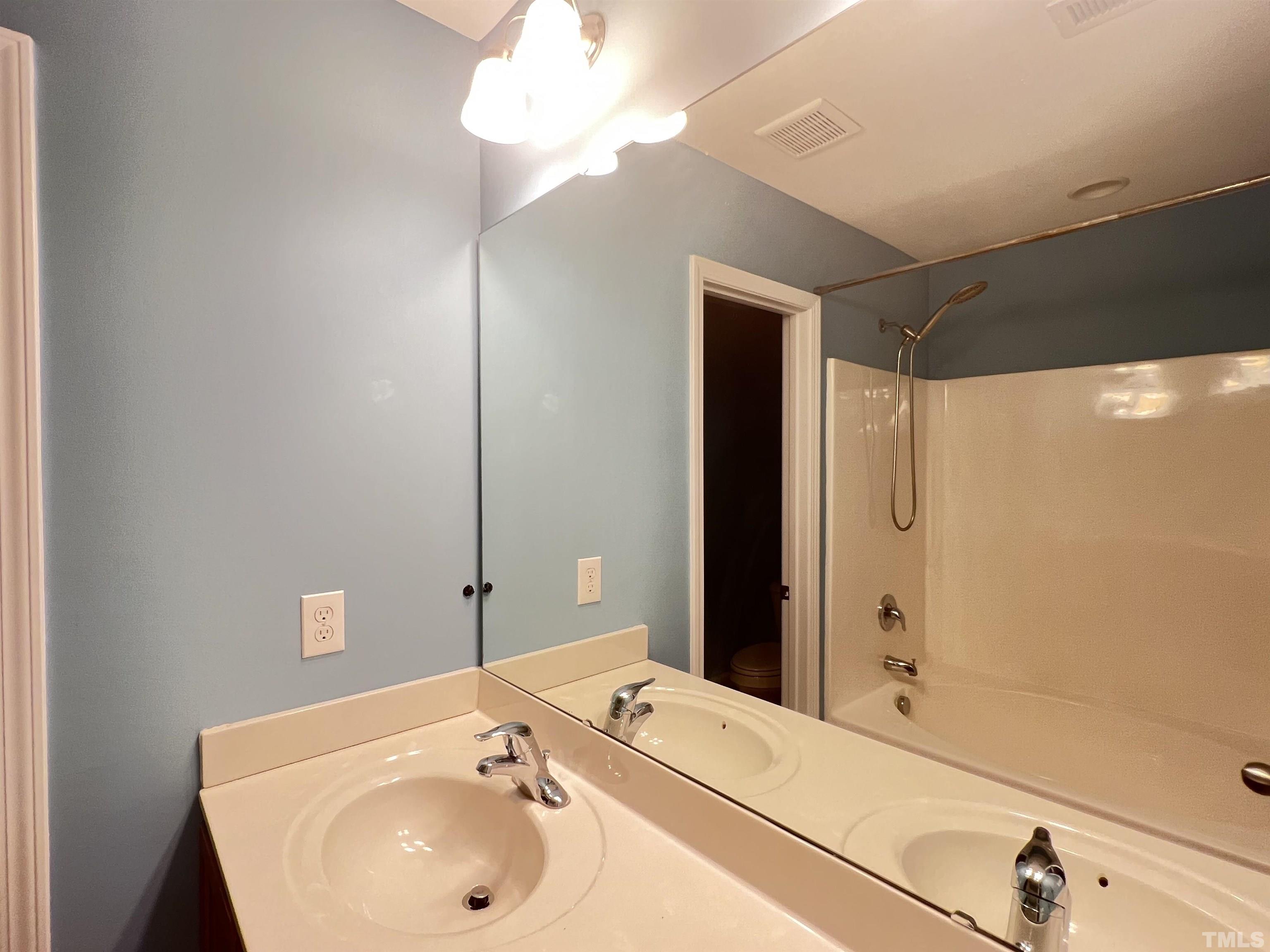 3012 Summerhouse Road Cary, NC 27519 - Photo 20 of 26 a bathroom with a sink and a mirror
