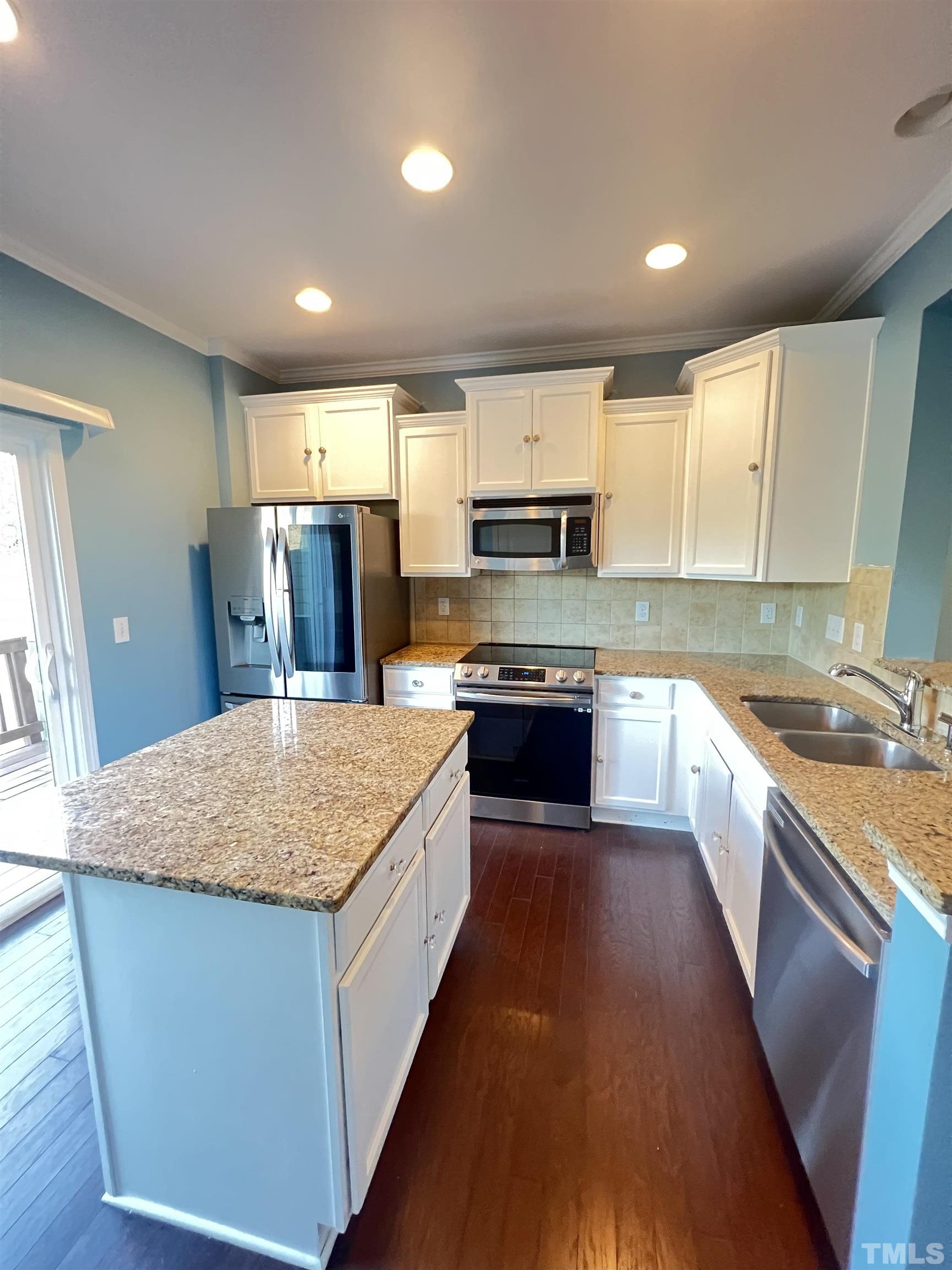 3012 Summerhouse Road Cary, NC 27519 - Photo 4 of 26 a large kitchen with kitchen island a sink stainless steel appliances and cabinets