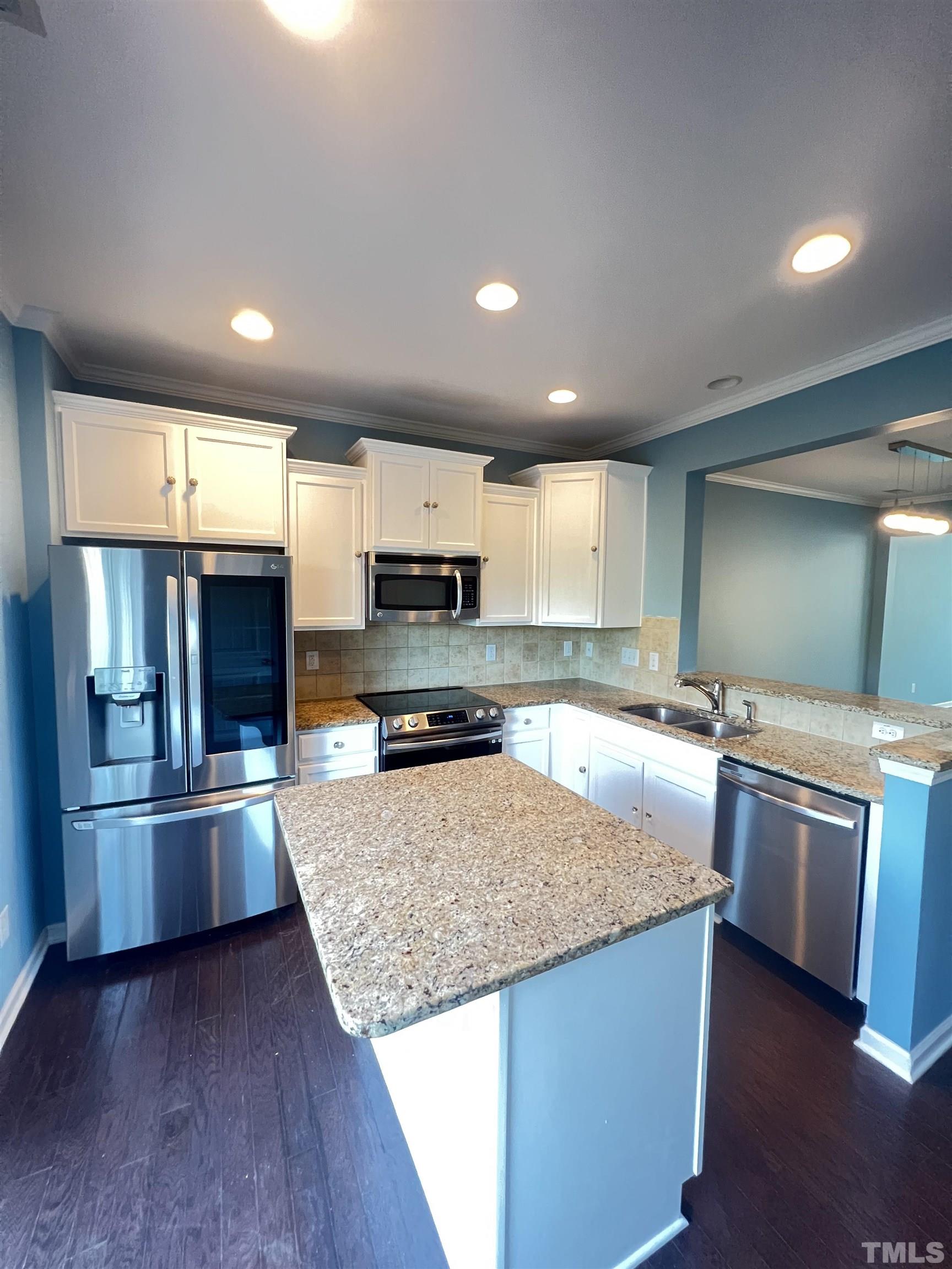 3012 Summerhouse Road Cary, NC 27519 - Photo 5 of 26 a kitchen with stainless steel appliances granite countertop a sink a stove top oven a refrigerator and dishwasher