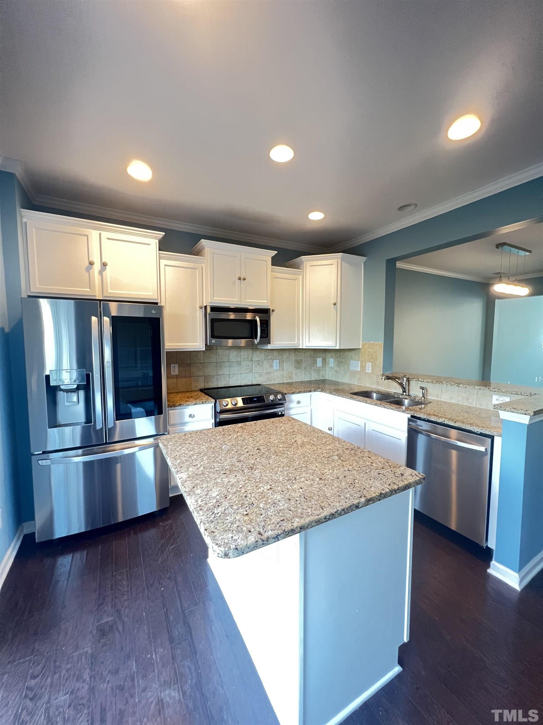 3012 Summerhouse Road Cary, NC 27519 - Photo 6 of 26 a kitchen with stainless steel appliances granite countertop a sink refrigerator and microwave