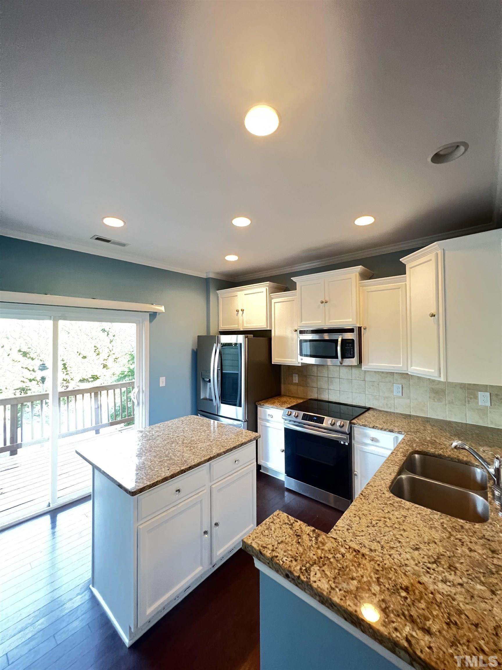 3012 Summerhouse Road Cary, NC 27519 - Photo 7 of 26 a kitchen with stainless steel appliances granite countertop a sink stove and refrigerator