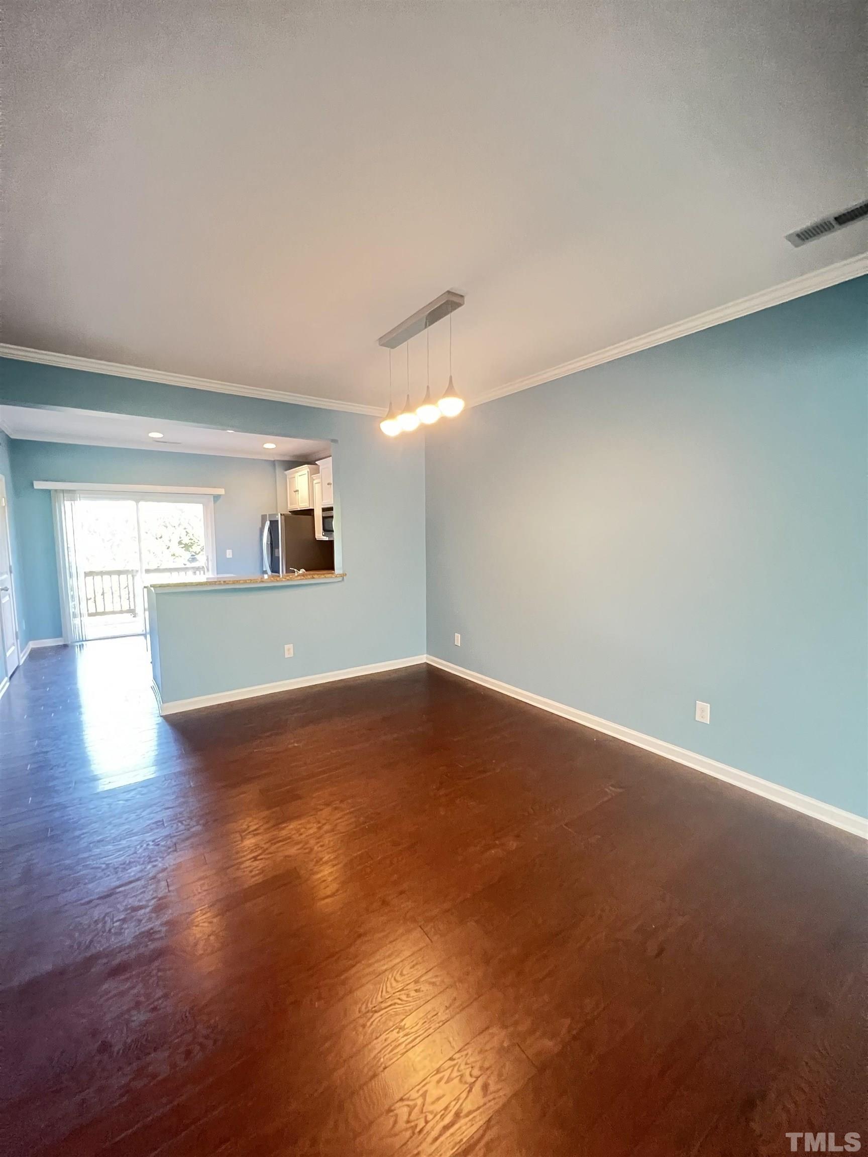 3012 Summerhouse Road Cary, NC 27519 - Photo 8 of 26 an empty room with wooden floor and windows