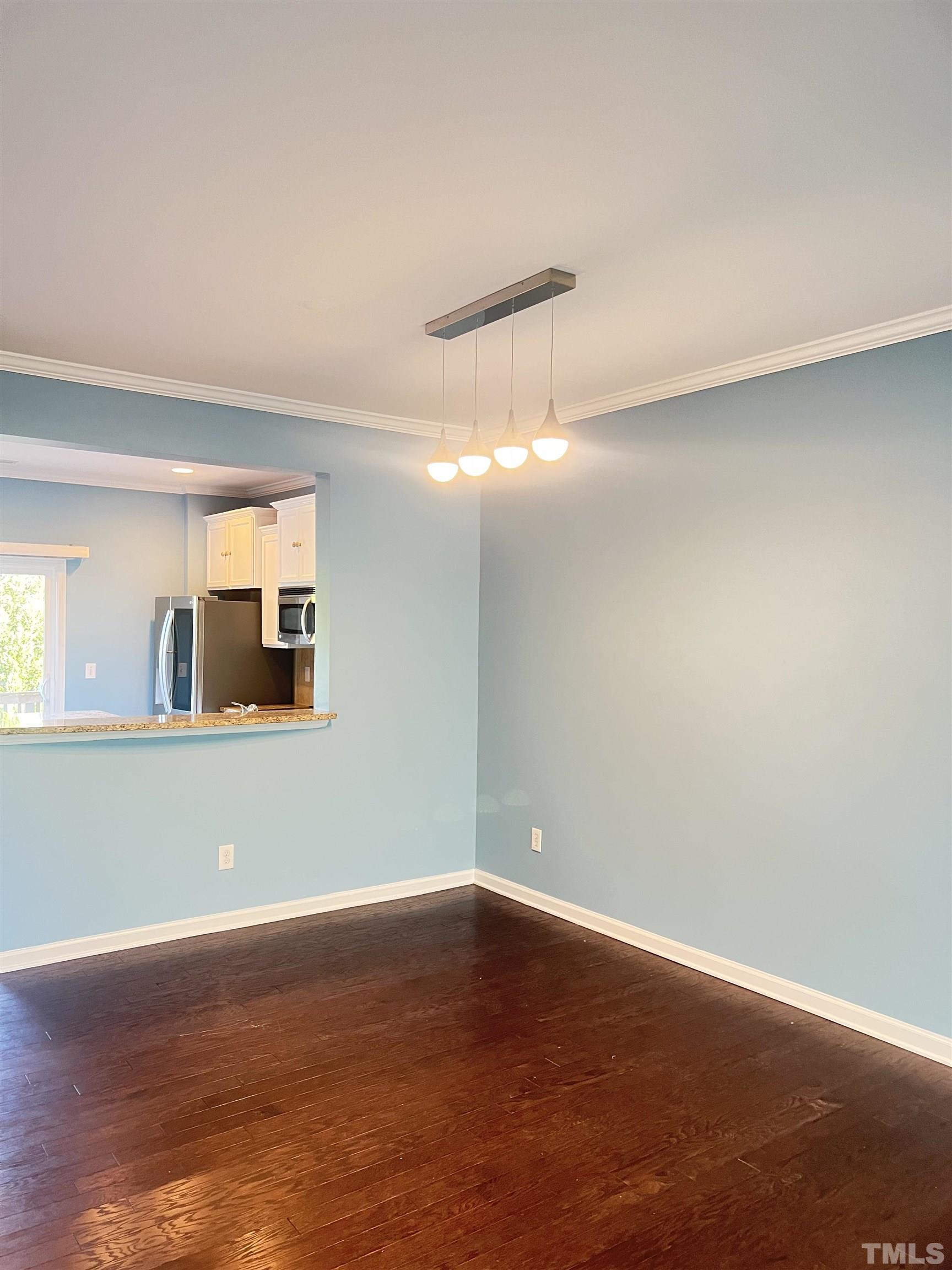 3012 Summerhouse Road Cary, NC 27519 - Photo 10 of 26 a view of an empty room with wooden floor and a window